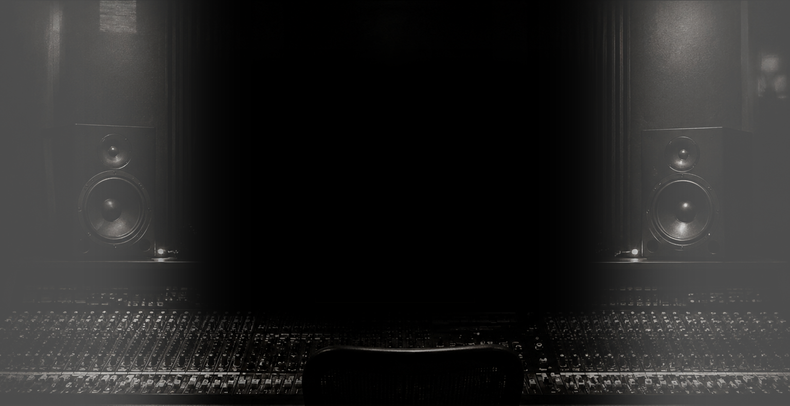 Studio speakers above a recording console